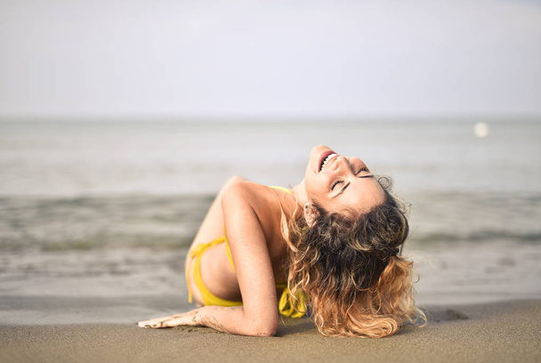 beautiful young woman on the beach - Фото, изображение