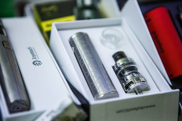 KIEV,UKRAINE-28 OCTOBER,2018: New vaping device and dripper head with titanium wire for smokine e-liquid. Buy new vaper gagdet in store - Photo, image