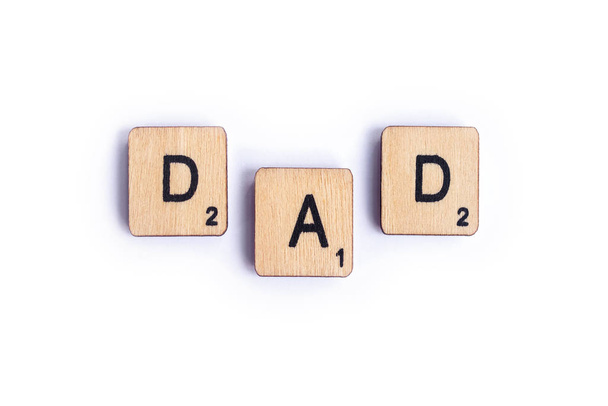 LONDON, UK - JULY 7TH 2018: The word DAD spelt with wooden letter Scrabble tiles, on 7th July 2018. - Photo, image