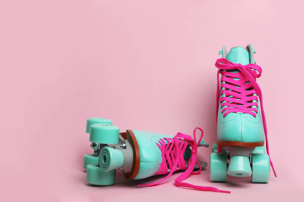 Pair of stylish quad roller skates on color background. Space for text - Fotó, kép