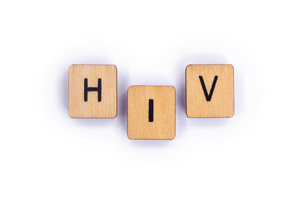 The abbreviation HIV, spelt with wooden letter tiles. - Фото, изображение