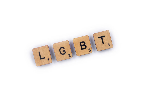 London, UK - July 8th 2018: The abbreviation LGBT - standing for lesbian, gay, bisexual, and transgender, spelt with wooden letter tiles over a plain white background.  - Fotografie, Obrázek
