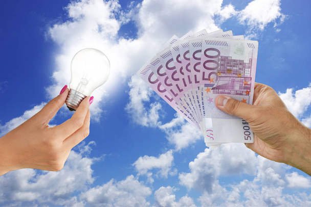 Paying for innovation concept with light bulb and cash money under blue sky background - Fotoğraf, Görsel