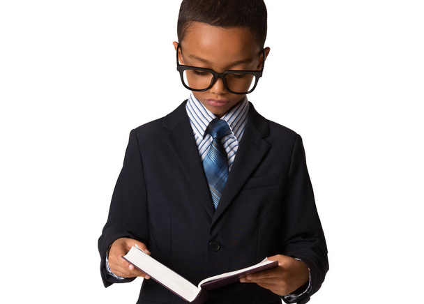 Elegant little african-american boy with glasses in business suit hold the book. Studio shot. Young boy posing. - Valokuva, kuva