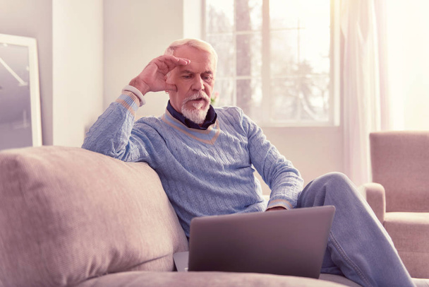 Meditative old man spending time with laptop - Photo, image