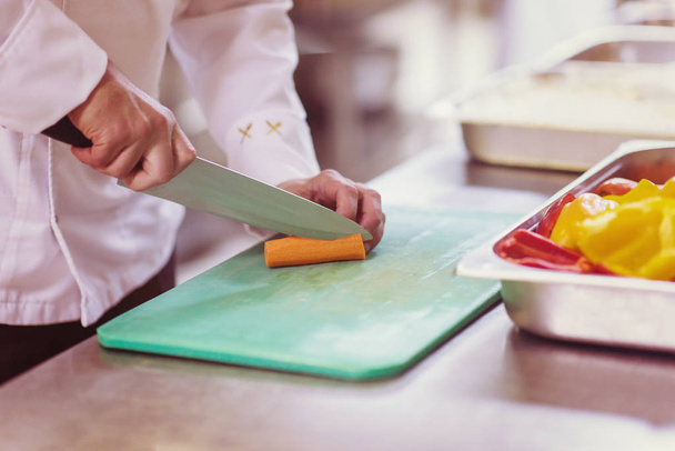 Chef hands cutting fresh and delicious vegetables for cooking or salad - Foto, Imagem