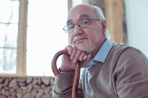 Portrait of attentive bearded pensioner that looking at camera - Fotó, kép