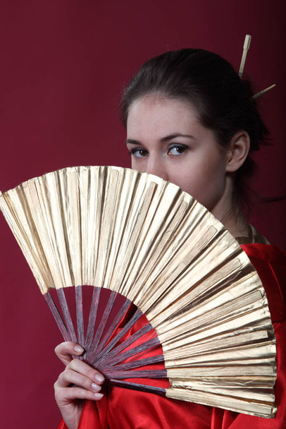 Beautiful brunette girl in a japanese kimono  - Zdjęcie, obraz