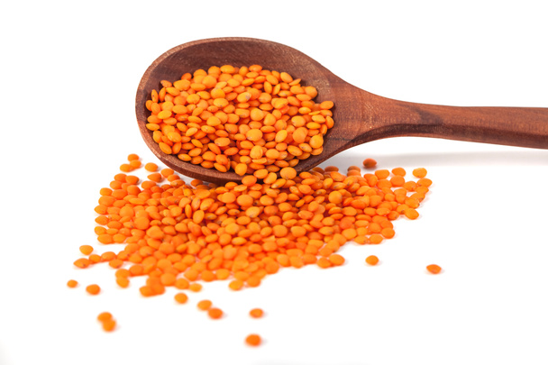 Red lentils in the wooden spoon, isolated on white background - Photo, Image