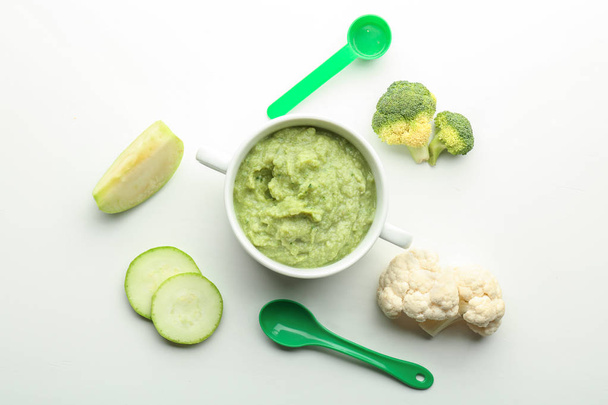 Flat lay composition with healthy baby food in casserole and ingredients on white background - Φωτογραφία, εικόνα