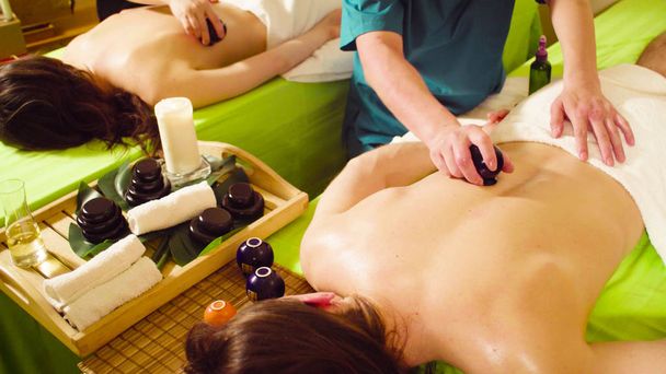 Two chinese therapists doing vacuum massage of the back - Photo, Image