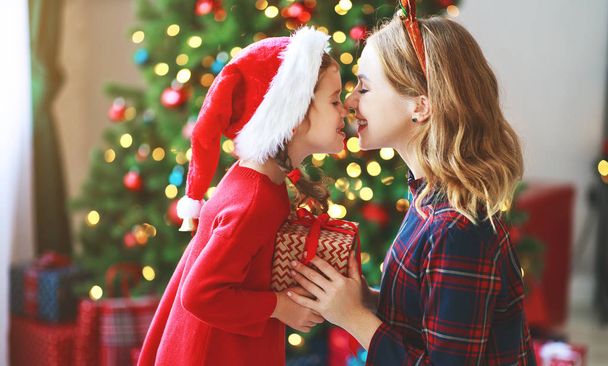 happy family mother and child daughter  open presents on Christmas mornin - Foto, imagen