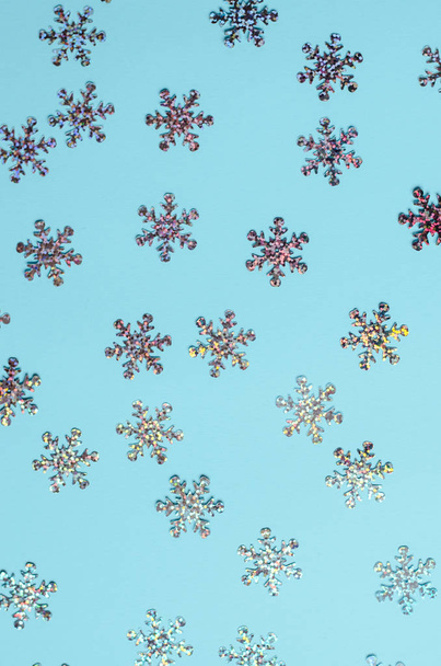 Muchos copos de nieve brillantes sobre un fondo azul
. - Foto, imagen