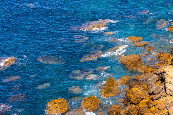 Aerial view of sea or ocean waves and some of rocks. - Foto, Imagen