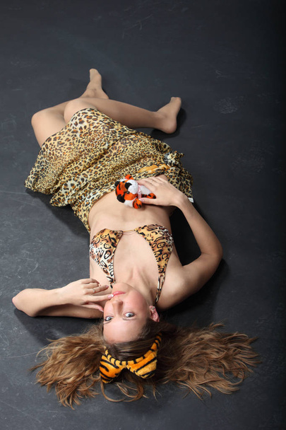 young seductive woman posing in leopard skin - 写真・画像