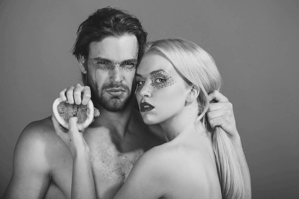 young couple of woman and man with makeup hold grapefruit - Foto, immagini