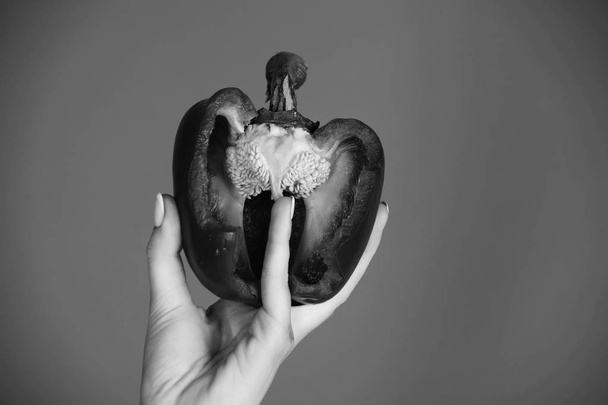half of bell pepper in hand of woman, heart - Fotoğraf, Görsel