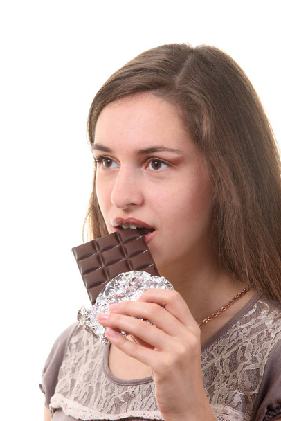 Young attractive woman eating  chocolate - Foto, imagen