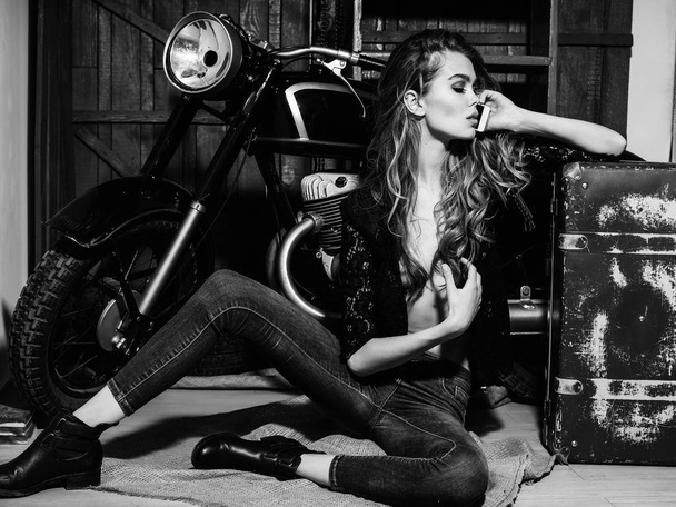 sexy girl biker with suitcase at motorcycle hold mobile phone - Fotografie, Obrázek