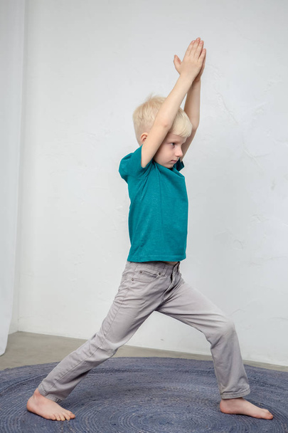 little boy is making yoga isolated over white background - Foto, Imagen