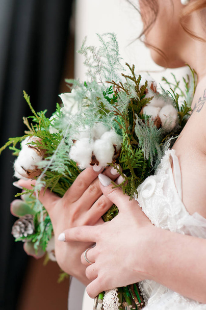 bride in white dress and dark hair preparations for the wedding - Фото, зображення