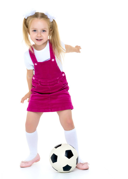 Little girl with a soccer ball. - Фото, изображение