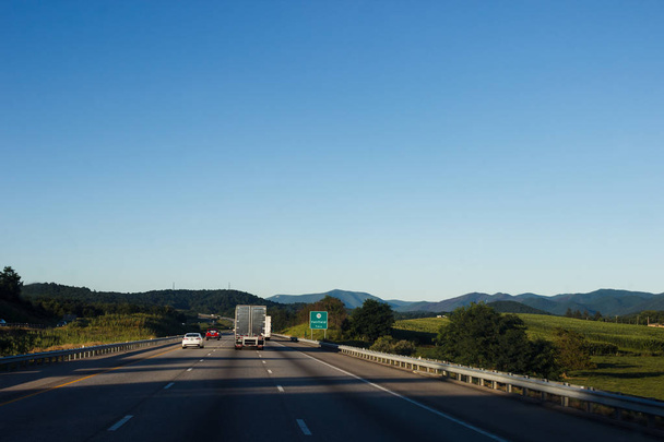 Cars and trucks drive along a beautiful scenic highway among mountains and hills on a sunny summer day. North Carolina / USA - July 8, 2018 - Valokuva, kuva