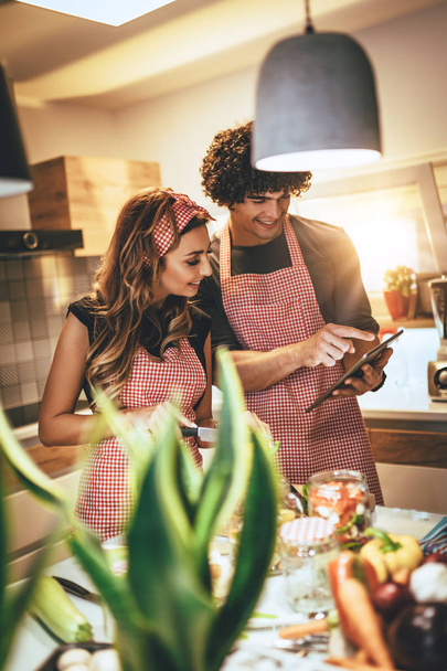 Feliz pareja joven divirtiéndose en hacer comida saludable juntos en la cocina casera
 - Foto, imagen