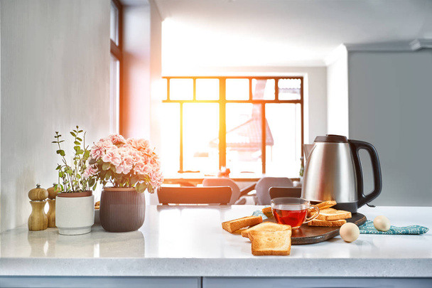 A cup of black tea with Sandwiches or toasts on white table. Sun flare - Fotoğraf, Görsel