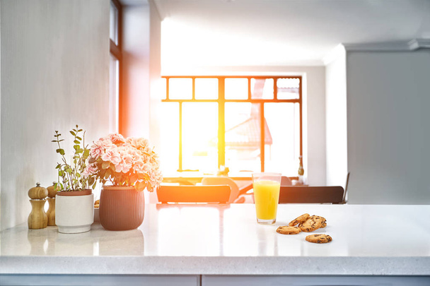 食欲をそそる甘いオレンジ ジュース、朝食を台所の白いテーブルの上に立ってグラス 1. - 写真・画像