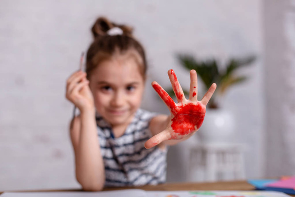 Koulutus, koulu, taide ja maalaus käsite - hymyilevä pieni opiskelija tyttö näyttää maalatut kädet koulussa
 - Valokuva, kuva