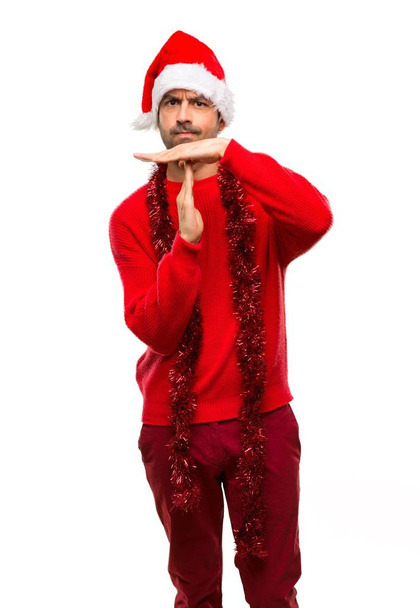 Mann mit roter Kleidung feiert die Weihnachtsfeiertage und macht Stop-Geste mit ihrer Hand, um einen Akt auf isoliertem weißem Hintergrund zu stoppen - Foto, Bild