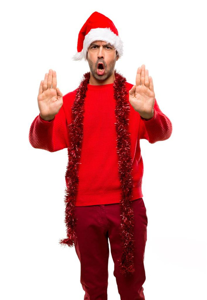 Man with red clothes celebrating the Christmas holidays making stop gesture for disappointed with an opinion on isolated white background - Zdjęcie, obraz