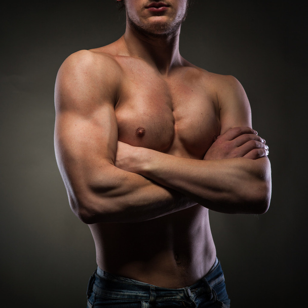 Muscular naked man on black - Фото, зображення