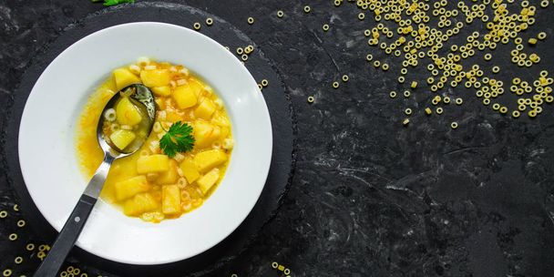 La sopa, hortalizas, la pasta y hortalizas - el primer plato (el fondo oscuro). comida vegana. Vista superior. espacio de copia
 - Foto, imagen