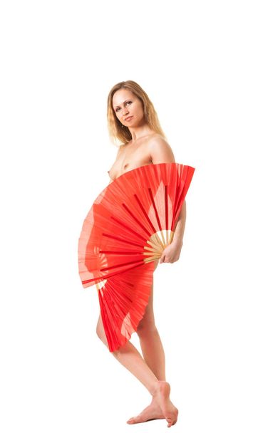Young attractive naked woman dancing  with two red fans - Foto, Imagem