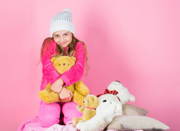 Kid little girl play with soft toy teddy bear pink background. Teddy bears improve psychological wellbeing. Unique attachments to stuffed animals. Child small girl playful hold teddy bear plush toy - Fotoğraf, Görsel