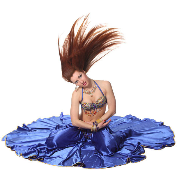 Young beautiful belly dancer in a blue costume - Foto, Imagem