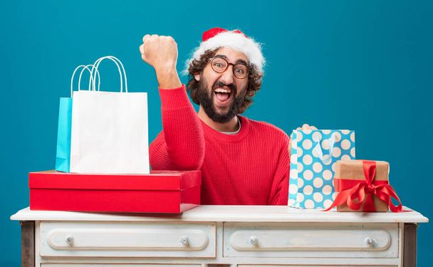 Young man with gifts. Christmas concept. - Фото, изображение