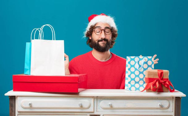 Young man with gifts. Christmas concept. - Zdjęcie, obraz