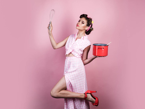 perfect housewife. pinup girl with fashion hair. retro woman cooking in kitchen. pin up woman with trendy makeup. pretty girl in vintage style. Enjoying new great day - Photo, image