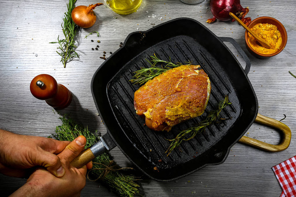 piece marinated meat prepared for cooking roast meat with thyme and spices on grill iron pan. top view. cooking recipe. - Valokuva, kuva