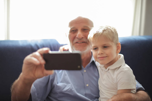grandfather and grandchild taking selfies - Fotoğraf, Görsel