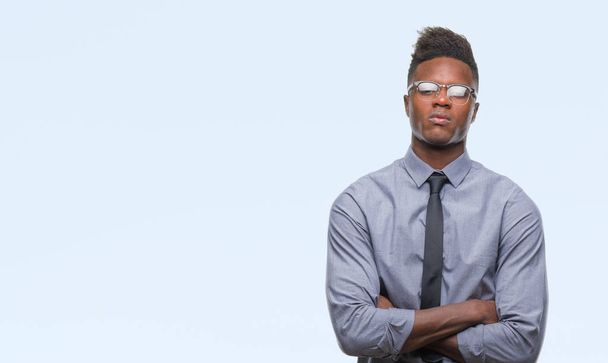 Young african american business man over isolated background skeptic and nervous, disapproving expression on face with crossed arms. Negative person. - Photo, Image