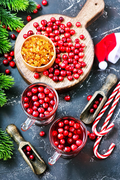 top view of christmas candy canes and cranberry drinks with berries on dark tabletop - Foto, immagini