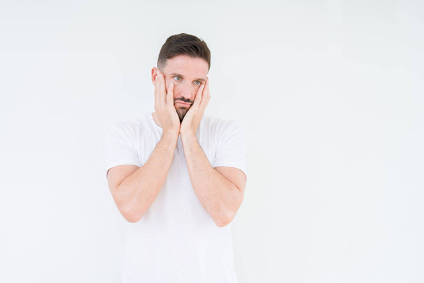 Young handsome man wearing casual white t-shirt over isolated background Tired hands covering face, depression and sadness, upset and irritated for problem - Foto, Imagen