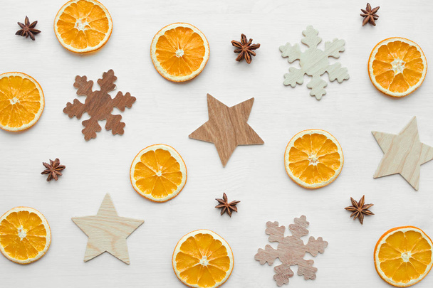 composition with dry oranges, anise stars and wooden snowflakes and stars - Φωτογραφία, εικόνα