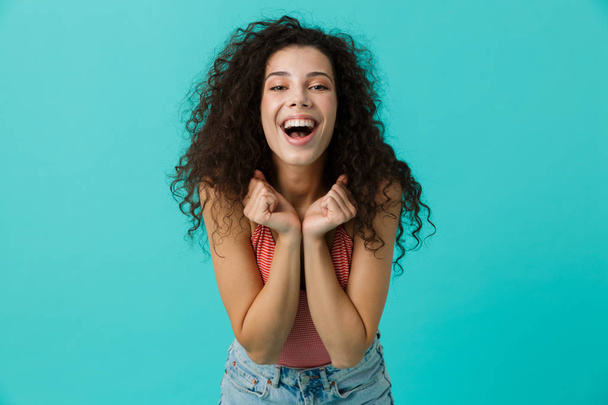 Image of caucasian woman 20s wearing casual clothing laughing standing isolated over blue background - Photo, Image