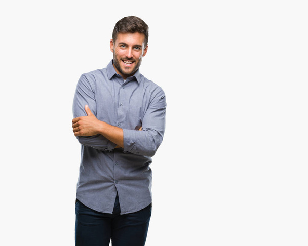 Young handsome man over isolated background happy face smiling with crossed arms looking at the camera. Positive person. - Photo, image