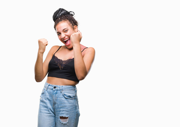 Young braided hair african american with pigmentation blemish birth mark over isolated background very happy and excited doing winner gesture with arms raised, smiling and screaming for success. Celebration concept. - Foto, Bild